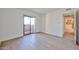 Bright living room with wood floors, baseboards, and access to the kitchen and outdoor patio at 5757 W Eugie Ave # 2068, Glendale, AZ 85304
