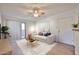Bright living room featuring a modern sofa, stylish coffee table, and a ceiling fan at 5757 W Eugie Ave # 2068, Glendale, AZ 85304