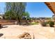 Backyard with stone tile, desert landscaping, block wall and sunny skies at 5919 W Straight Arrow Ln, Phoenix, AZ 85083