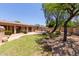 Expansive backyard featuring a built-in grill area, mature landscaping, and a well-maintained lawn at 5919 W Straight Arrow Ln, Phoenix, AZ 85083