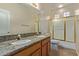 Bathroom with dual sinks, granite counters, tub/shower combo and tile floors at 5919 W Straight Arrow Ln, Phoenix, AZ 85083