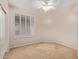 Bedroom with ceiling fan, shuttered window, and neutral walls and carpet at 5919 W Straight Arrow Ln, Phoenix, AZ 85083