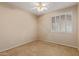 Bright bedroom features neutral walls, ceiling fan and shuttered window at 5919 W Straight Arrow Ln, Phoenix, AZ 85083