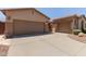 Exterior of home featuring an attached two-car garage and extended driveway at 5919 W Straight Arrow Ln, Phoenix, AZ 85083
