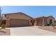 Lovely home showcasing a spacious driveway, two-car garage, and low-maintenance desert landscaping at 5919 W Straight Arrow Ln, Phoenix, AZ 85083