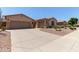 Lovely home showcasing a spacious driveway, two-car garage, and low-maintenance desert landscaping at 5919 W Straight Arrow Ln, Phoenix, AZ 85083