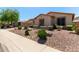 Well-manicured front yard with desert landscaping complements this inviting home at 5919 W Straight Arrow Ln, Phoenix, AZ 85083