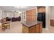 Spacious kitchen features tile floors, a central island, and seamless flow to the living room at 5919 W Straight Arrow Ln, Phoenix, AZ 85083