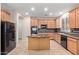 Modern kitchen with tile floors, a center island, and contemporary appliances at 5919 W Straight Arrow Ln, Phoenix, AZ 85083