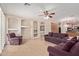 Open-concept living room boasts tile flooring, built-in shelving, and seamless flow to the kitchen at 5919 W Straight Arrow Ln, Phoenix, AZ 85083