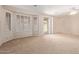 Expansive living room featuring a ceiling fan and large windows at 5919 W Straight Arrow Ln, Phoenix, AZ 85083