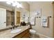 Neutral bathroom with granite counters, cabinets, framed mirror and walk-in shower at 5957 W Robin Ln, Glendale, AZ 85310