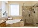 Bathroom with a tub, walk-in shower, granite counters and tiled floors at 5957 W Robin Ln, Glendale, AZ 85310