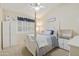 Comfortable bedroom featuring a classic bed frame, bright interior, and a window with natural light at 5957 W Robin Ln, Glendale, AZ 85310