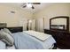 Relaxing bedroom with dresser, serene colors, plush bedding, a mounted fan, and lots of storage at 5957 W Robin Ln, Glendale, AZ 85310