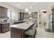 Beautiful kitchen with stainless steel appliances, granite countertops, island seating, and stylish pendant lighting at 5957 W Robin Ln, Glendale, AZ 85310