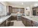 Gourmet kitchen featuring stainless steel appliances, granite countertops, and ample cabinet space at 5957 W Robin Ln, Glendale, AZ 85310