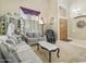 Comfortable living room with neutral carpet, elegant sofas, and natural light at 5957 W Robin Ln, Glendale, AZ 85310