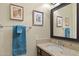 Bathroom vanity with dark wood cabinets, neutral counters, and framed prints at 6231 E Mark Way # 14, Cave Creek, AZ 85331