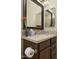 Bathroom vanity with dark wood cabinets, neutral counters and stainless steel fixtures at 6231 E Mark Way # 14, Cave Creek, AZ 85331