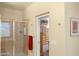 Bathroom featuring a glass shower, stone walls, and an ensuite doorway at 6231 E Mark Way # 14, Cave Creek, AZ 85331