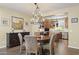 Dining room features a round wood table with seating for four and an elegant chandelier lighting fixture at 6231 E Mark Way # 14, Cave Creek, AZ 85331