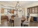 This dining area showcases an open floor plan with wood floors, a wine fridge, and seamless access to the kitchen at 6231 E Mark Way # 14, Cave Creek, AZ 85331