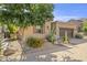 Front yard of a single-story home featuring desert landscaping, a tree, and a brick driveway at 6231 E Mark Way # 14, Cave Creek, AZ 85331
