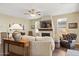 Bright living room featuring a fireplace, comfortable seating, and backyard view at 6231 E Mark Way # 14, Cave Creek, AZ 85331