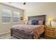 Comfortable main bedroom with a wood-framed bed, cozy bedding, and a ceiling fan for enhanced air circulation at 6231 E Mark Way # 14, Cave Creek, AZ 85331