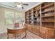 Well-lit home office with built-in shelving and a decorative ceiling fan at 6231 E Mark Way # 14, Cave Creek, AZ 85331