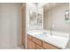 Neutral bathroom featuring a large mirror and light wood vanity at 7101 W Beardsley Rd # 542, Glendale, AZ 85308
