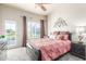Comfortable bedroom featuring a ceiling fan, a queen-sized bed, and access to the backyard at 7101 W Beardsley Rd # 542, Glendale, AZ 85308