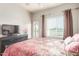 Comfortable bedroom with a dresser, TV, and an outdoor patio door at 7101 W Beardsley Rd # 542, Glendale, AZ 85308