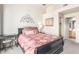 A relaxing bedroom with a black sleigh bed, ceiling fan, and access to an ensuite bathroom at 7101 W Beardsley Rd # 542, Glendale, AZ 85308