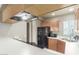 Open kitchen layout with wooden cabinets, black appliances, and light countertops and walls at 7101 W Beardsley Rd # 542, Glendale, AZ 85308