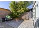 Backyard with stone-tiled patio, gravel, and block fence at 7132 N 63Rd Dr, Glendale, AZ 85301