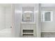 Modern bathroom with vanity, white marble countertop, and tile in shower/tub at 7132 N 63Rd Dr, Glendale, AZ 85301
