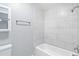 Bright bathroom with shower and tub tiled with marble throughout at 7132 N 63Rd Dr, Glendale, AZ 85301