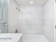 White tile shower with marble accents and modern showerhead at 7132 N 63Rd Dr, Glendale, AZ 85301