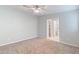 Spacious bedroom features neutral carpet, ceiling fan, and ensuite bathroom access at 7132 N 63Rd Dr, Glendale, AZ 85301