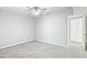 Bedroom with carpet, fan, neutral walls and bright natural lighting from the open door at 7132 N 63Rd Dr, Glendale, AZ 85301