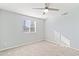 Bright bedroom with ceiling fan, neutral carpet, and window allowing natural light at 7132 N 63Rd Dr, Glendale, AZ 85301