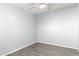 Clean, empty bedroom with gray vinyl floors, gray walls, and ceiling fan at 7132 N 63Rd Dr, Glendale, AZ 85301