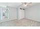 Bedroom with fan, neutral walls, carpet, bright lighting and white closet doors at 7132 N 63Rd Dr, Glendale, AZ 85301