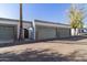Row of garages with neutral paint, each featuring roll-up doors and trees at 7132 N 63Rd Dr, Glendale, AZ 85301
