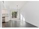 Open floor plan with gray vinyl floors, adjacent to a modern kitchen and dining area at 7132 N 63Rd Dr, Glendale, AZ 85301