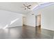 Bright living room with vaulted ceiling, gray vinyl floors, and neutral walls at 7132 N 63Rd Dr, Glendale, AZ 85301