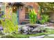 Lush backyard showcasing a serene pond with a quaint bridge and vibrant foliage near the brick house at 725 W Portland St, Phoenix, AZ 85007