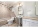 Bright bathroom showcasing a toilet, pedestal sink, and vanity with light fixtures and neutral finishes at 725 W Portland St, Phoenix, AZ 85007